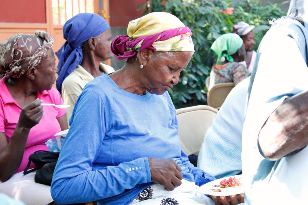 Volunteers distributing meals to elderly community members